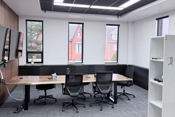 Boardroom with a live-edge table, chairs, and view of residential houses outside. - 2nd Floor - 139 Mulock Avenue, Toronto