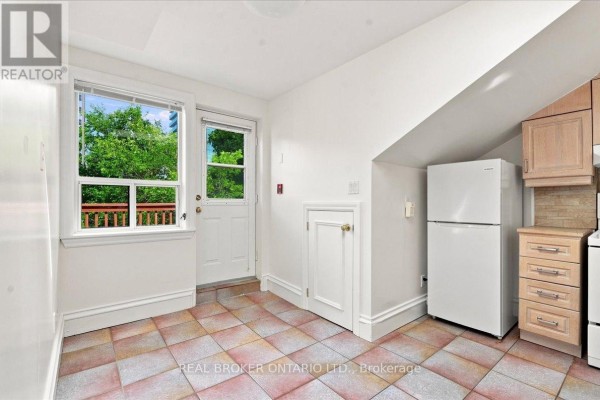 Room with slanted ceiling, built-in closet, and large window. - 3 - 12 Foxbar Road, Toronto