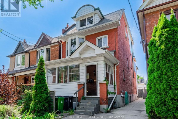Side view of a red brick two-story house with a white porch and a driveway on the right. - 3 - 12 Salem Avenue, Toronto