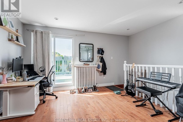 Room with hardwood floors, a desk, computer, and glass door leading to a balcony with white railing. - 3 - 12 Salem Avenue, Toronto