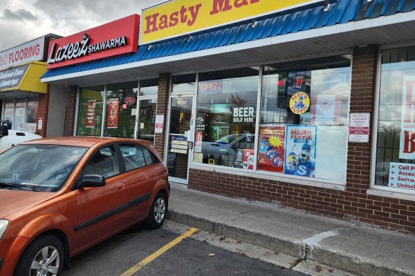 Close-up of Hasty Market entrance with 'OPEN' sign and product displays visible. - 3 - 136 Guelph Street, Halton Hills