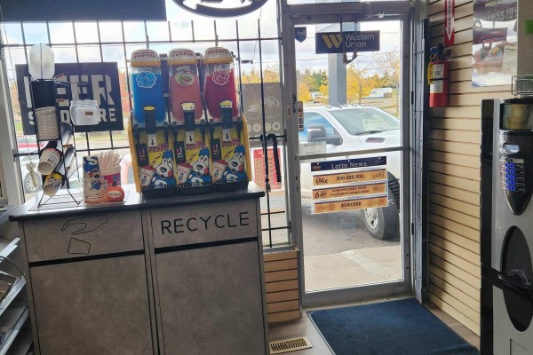 Another interior shot showing snack displays, beverage dispensers, and entrance door with Western Union sign. - 3 - 136 Guelph Street, Halton Hills
