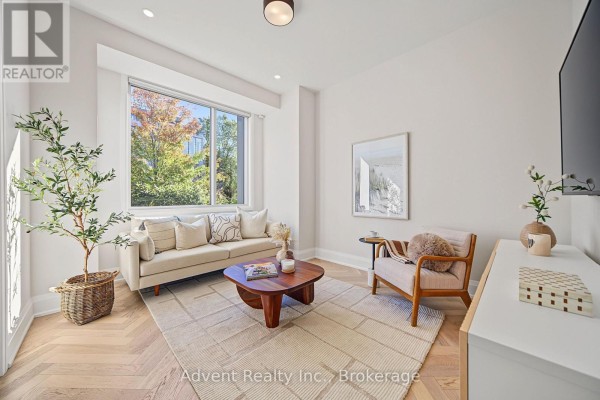 Dining table with four upholstered chairs against a neutral wall with vertical wood paneling and artwork. - 3 - 18 Greenbriar Road, Toronto