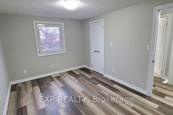 Living and dining area with tiled floor and wood plank flooring, and large windows. - 246 Lakeshore Road, St  Catharines