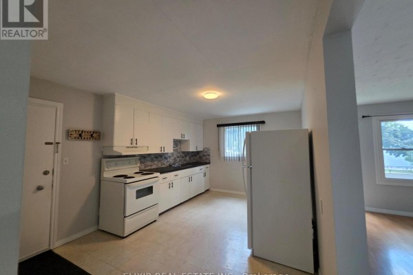Kitchen with white cabinets, white appliances, and a patterned backsplash. - 3 - 362 Grey Street, Brantford