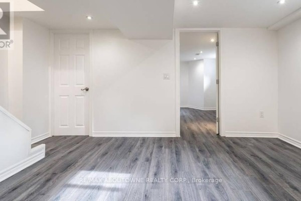 Interior room with white walls, grey wood-look flooring, white doors, and a staircase. - 3 - 43 Crooks Street, Hamilton