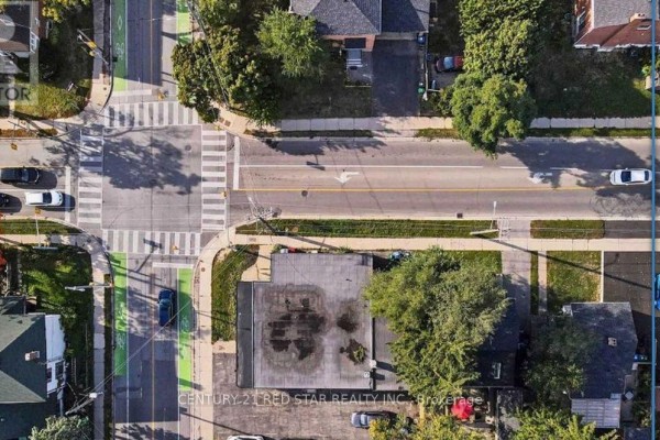 Overhead drone view of a commercial building at a busy intersection with traffic and bike lanes. - 3 - 44 Centre Street N, Brampton