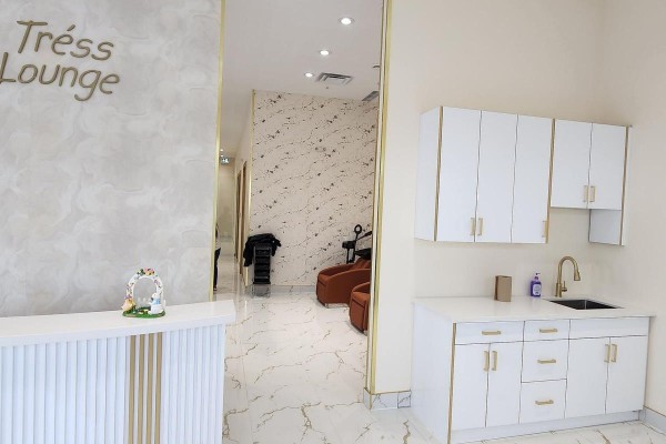 Reception desk and sink area with white cabinetry, gold fixtures, and marble flooring. - 3 - 45 Woodbine Downs Boulevard, Toronto