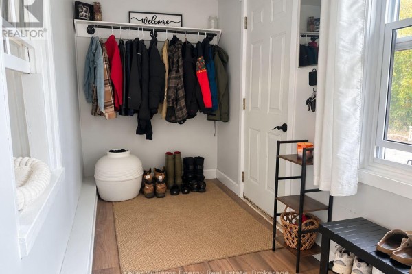Interior entryway with a coat rack, boots, and storage shelves. - 3 - 5 Crandall Street, Kawartha Lakes