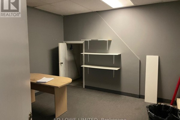 Interior room with grey walls, desk, three white shelves, and a doorway. - 3 - 511 Welham Road, Barrie