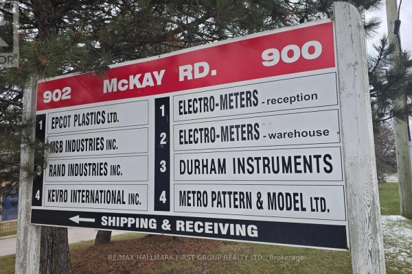 Empty commercial office space with multiple windows and blinds, light grey flooring. - 3 - 900 Mckay Road, Pickering