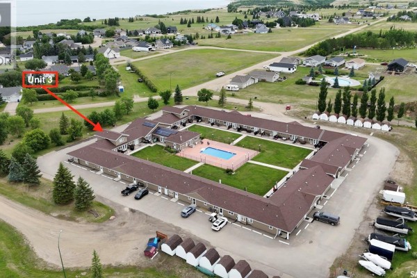 Aerial view of the complex, showing Unit 3 on the left side and surrounding green spaces. - 3 1250 Aaro Avenue, Elbow