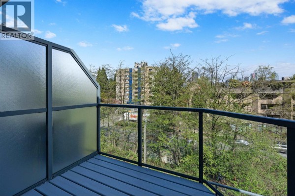 Balcony with glass railings and views of trees and city buildings. - 3 1355 W 4th Avenue, Vancouver