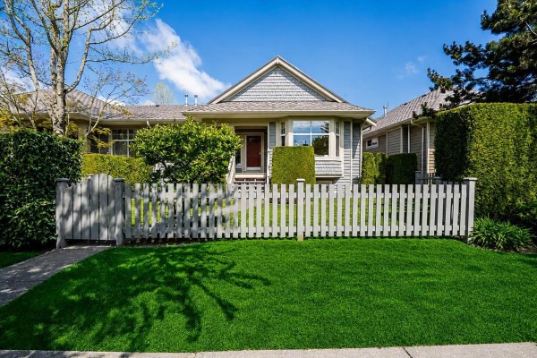 Close-up of the front entrance of a grey townhouse with a covered porch and stairs. - 3 15425 Rosemary Heights Crescent, Surrey