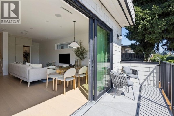 Balcony with seating, connected to the open concept living and dining area through sliding doors. - 3 2124 E 8 Avenue, Vancouver