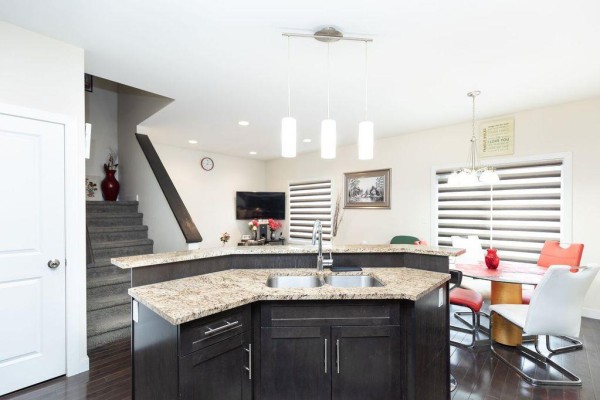 Wooden backyard deck with snow, a chair, and double glass doors leading into a townhouse. - 3 3381 Pembina Highway, Winnipeg
