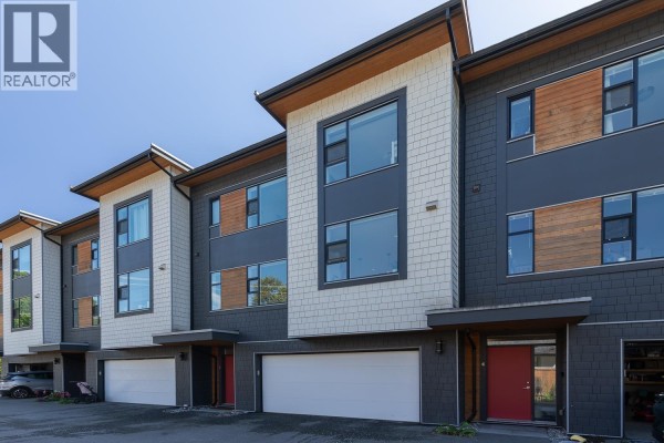 Backyard with patio, seating, fire pit, and stacked firewood. - 3 38447 Buckley Avenue, Squamish