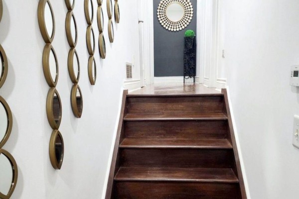 View up a wooden staircase with dark wood treads and risers, flanked by mirrors. - 3 Blackthorn Lane E, Brampton