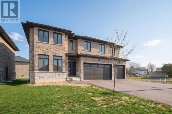 Side exterior view of a two-story brick house with a dark garage door and two-car garage. - 3 Bouw Street, Dutton/dunwich