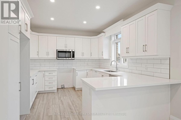 Modern white kitchen with shaker cabinets, quartz countertops, subway tile backsplash & island - 3 Bouw Street Dutton/dunwich