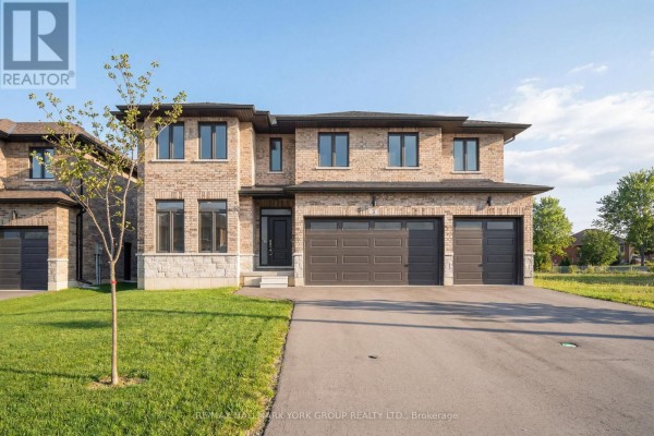 Front exterior view of a two-story brick house with a dark garage door and two-car garage. - 3 Bouw Street, Dutton/dunwich