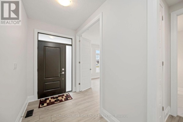Interior view of a front entryway with a dark front door, light wood floors, and white walls. - 3 Bouw Street, Dutton/dunwich