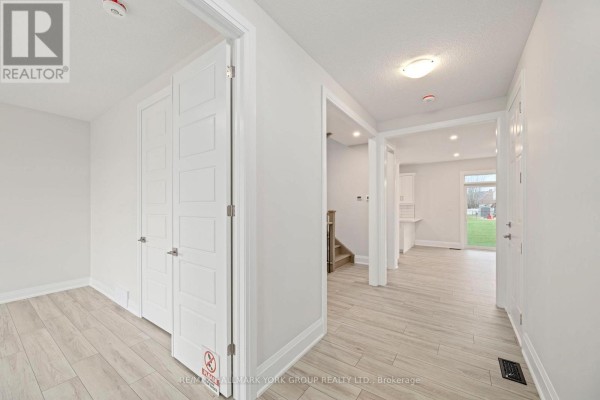 Interior view of a hallway with white doors, light wood floors, and an open view to the kitchen. - 3 Bouw Street, Dutton/dunwich