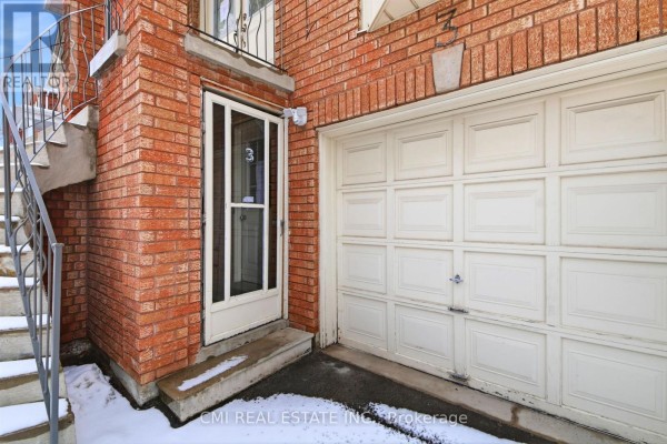 Detail of a front door with glass panels, address number 3, and a white garage door on the side. - 3 Forest Point Drive, Toronto