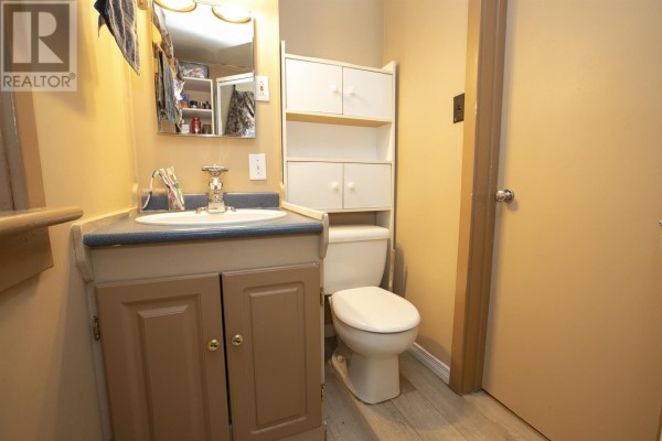Bathroom with vanity, sink, toilet, and storage cabinet - 3 Henrietta Ave Sault Ste Marie