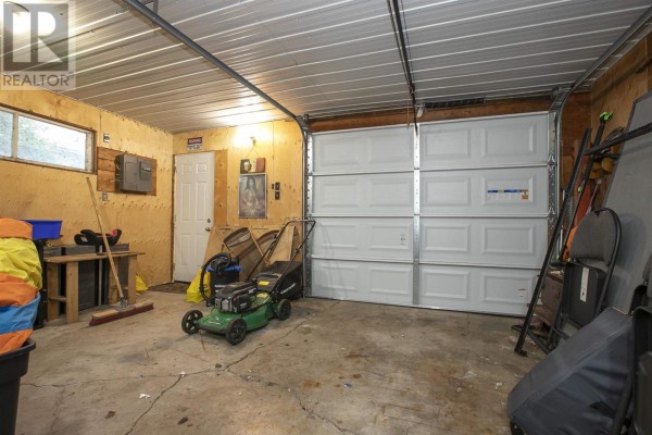 Garage with double door, lawn mower, and storage - 3 Henrietta Ave Sault Ste Marie
