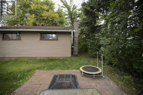 Backyard with fire pit and trampoline - 3 Henrietta Ave Sault Ste Marie
