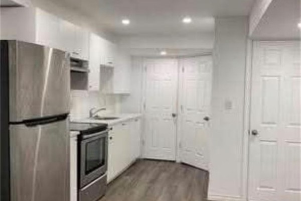 Small kitchen with stainless steel refrigerator, oven, white cabinets, and gray floors. - 3 Innswood Place Unit# Lower, Hamilton