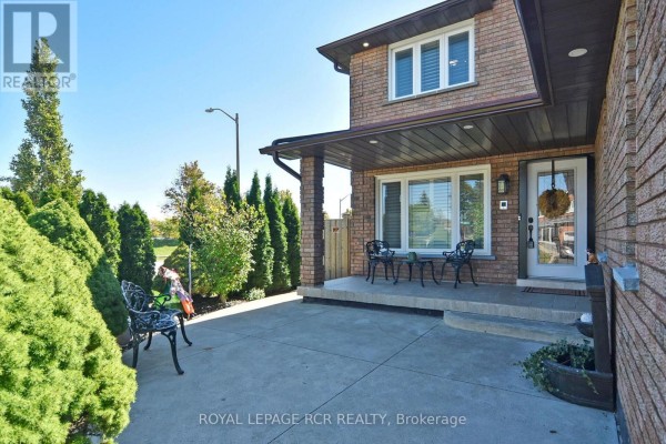 Covered front porch area with two wrought iron chairs and a small table. - 3 Jackman Crescent, Vaughan