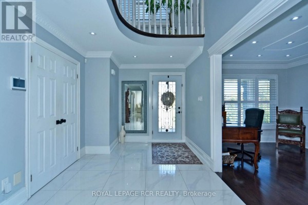 Interior foyer with light blue walls, white tiled floor, and double doors. - 3 Jackman Crescent, Vaughan
