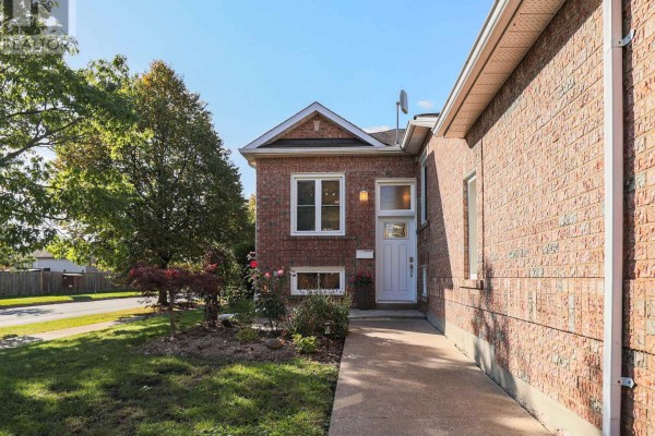 Close-up of the front entrance of a brick house with a white door and windows. - 3 Jackson Court W, Welland