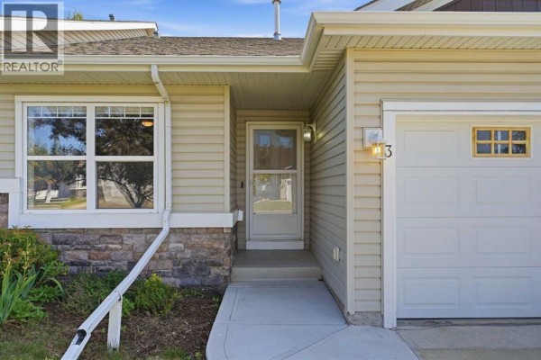 Detail of townhouse entrance at 3 Janko Close, Red Deer with beige siding. - 3 Janko Close, Red Deer