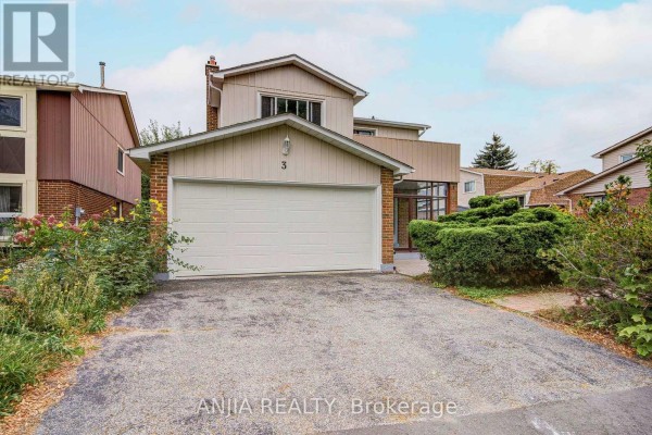 Close-up of the garage door and entrance of a beige and brick house. - 3 Mossbrook Crescent, Toronto