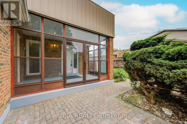 Glass enclosed entryway with brick and paving stone walkway. - 3 Mossbrook Crescent, Toronto