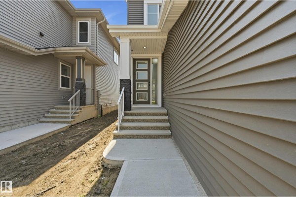 Aerial view of residential area with snow, showcasing nearby homes and open land. - 3 Pierwyck Lo, Spruce Grove
