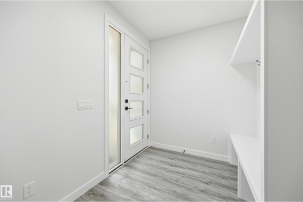 Entryway with modern front door, large window, and built-in bench with hooks. - 3 Pierwyck Lo, Spruce Grove