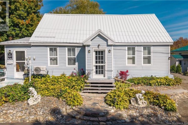 Front entrance of a light blue house with double doors and landscaped bushes. - 3 Pleasant Street, St  Stephen