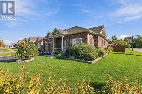 Side exterior view of a brick bungalow with a covered porch and neat landscaping. - 3 Pollock Avenue, Brock