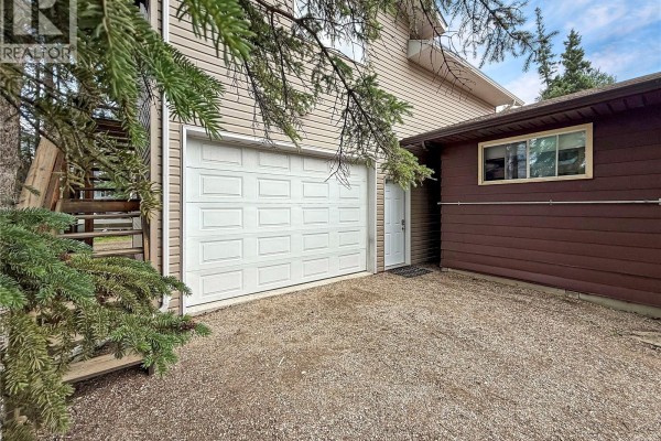 Living space with light wood ceiling, fireplace, and seating areas. - 3 White Spruce Crescent, Candle Lake
