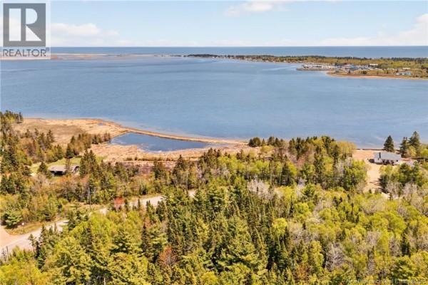 Aerial view of wooded property with water and distant tree line. - 3.36 Acres Rue De L'outarde, Pointe Des Robichaud