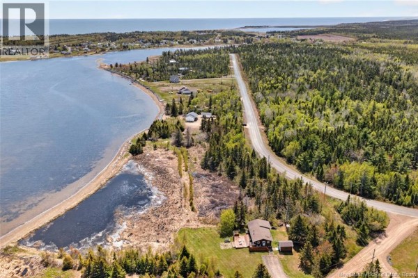 Aerial view of marshy water area with sandy shoreline and trees. - 3.36 Acres Rue De L'outarde, Pointe Des Robichaud