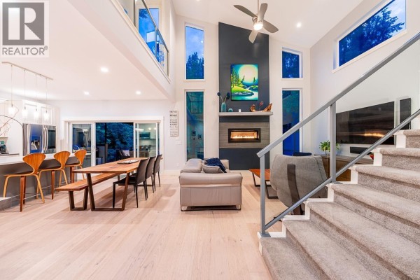 Open concept living and dining area with a fireplace and vaulted ceilings. - 30 3295 Sunnyside Road, Anmore