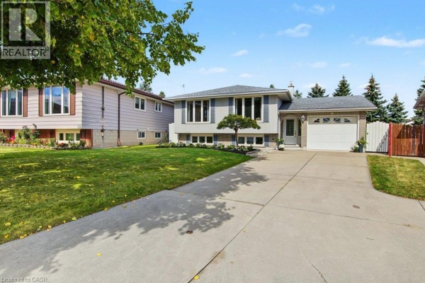 Front corner view of the house with a driveway leading to the garage and front entrance. - 30 Catalina Drive, Hamilton