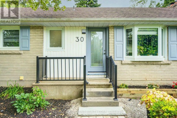 Close-up of the front entrance with a glass-paned door, bay window, and light blue shutters. - 30 Dale Avenue, Hamilton