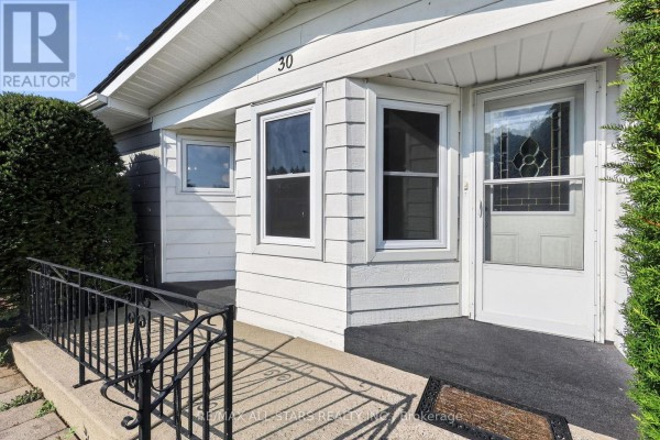 Close-up of the entrance to a single-story house with bay windows and a white door. - 30 Damsel Circle, Georgina