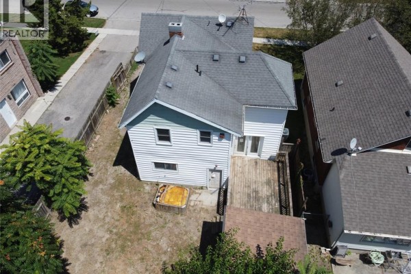 Aerial view of the back of the house, featuring a deck, hot tub, and a small shed. - 30 Delaware Avenue, Chatham